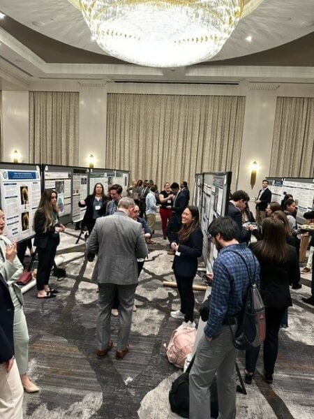 Attendees mingle & converse in a poster session at the 2024 SGIM Southern Regional Meeting
