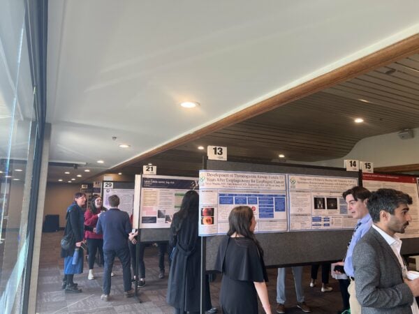 People mingle and converse in a poster session at the 2024 Northwest Regional Meeting.