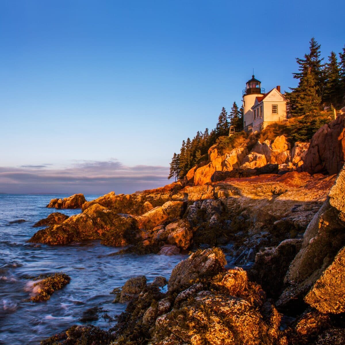 Image of a light house as seen from a rocky beach