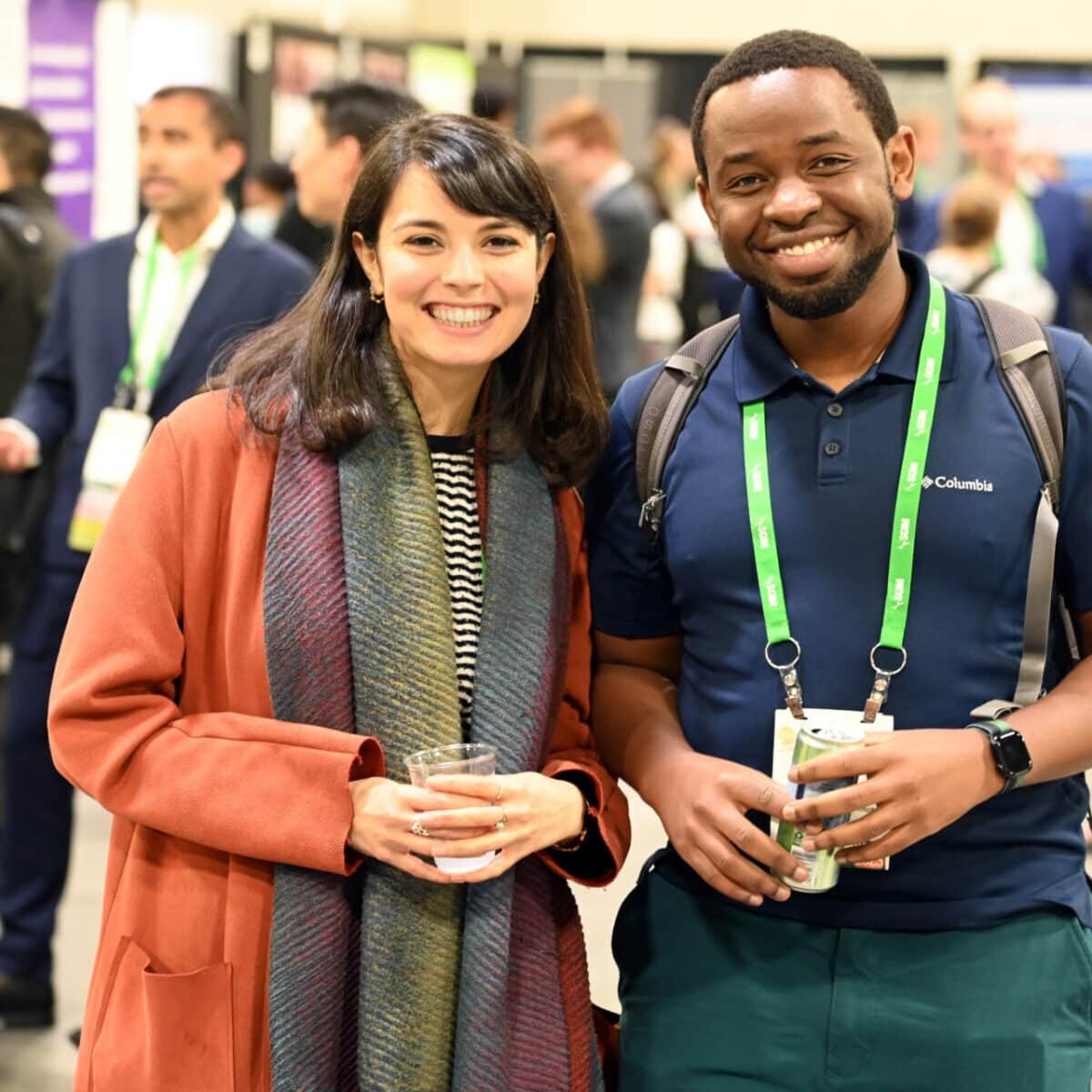 Two SGIM meeting attendees posing together holding beverages during a refreshment break.