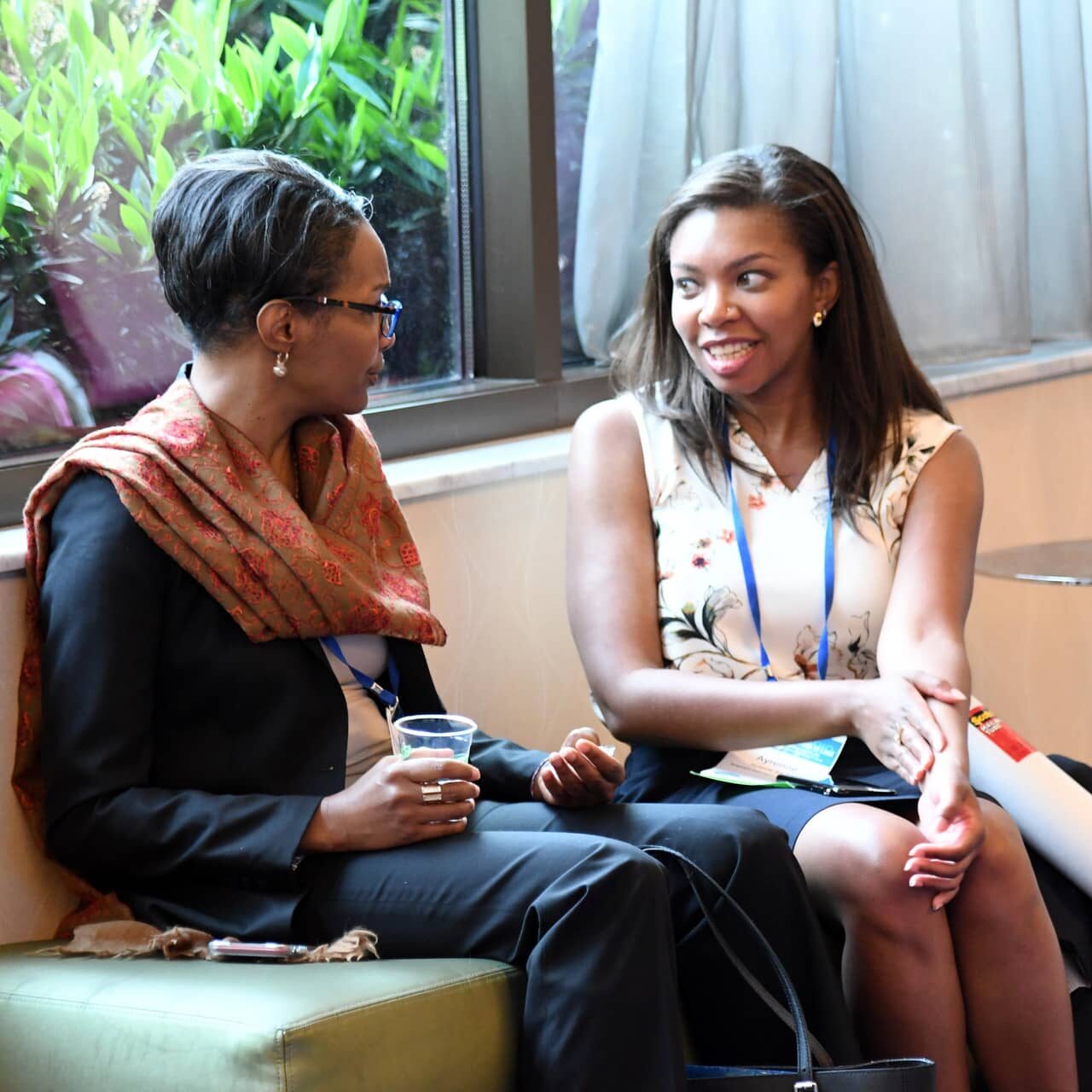 Image of conference attendees chatting during a break between sessions