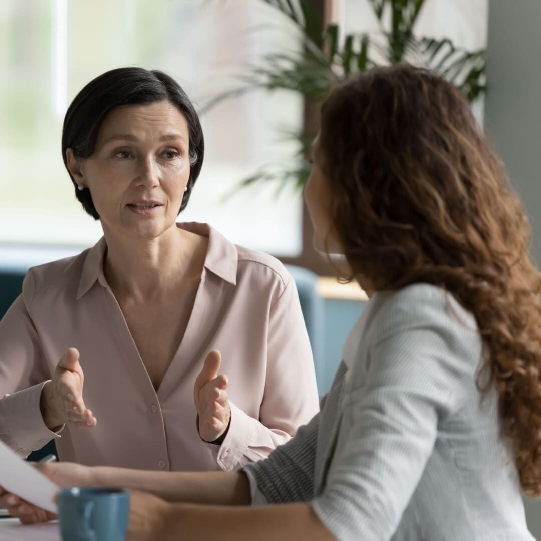 Businesswoman in an office setting having a discussion with a client.