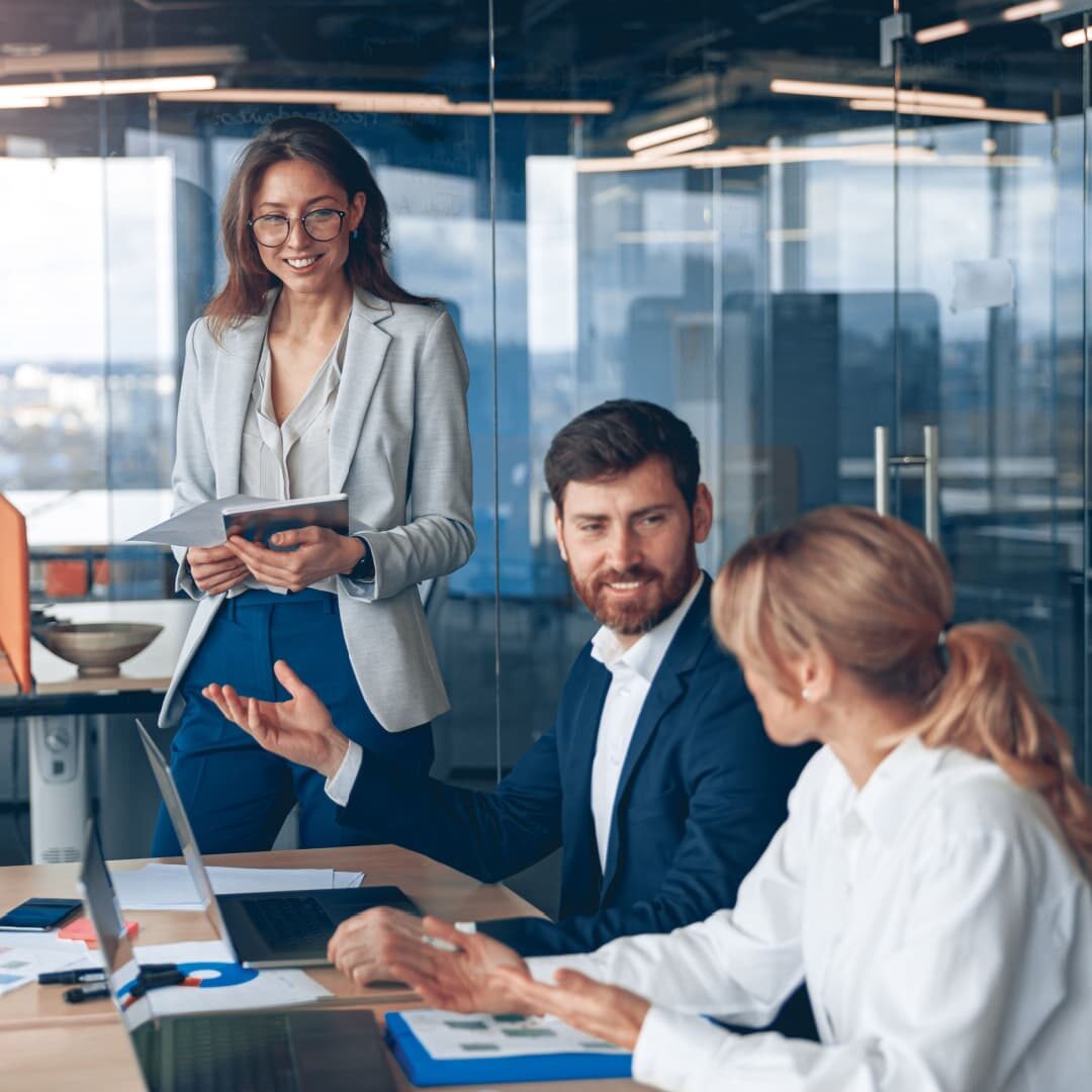 A group of professionals discussing business matters in a meeting room.