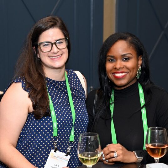 SGIM 2023 Cocktail Hour Two SGIM 2023 Annual Meeting attendees posing together during a cocktail hour.